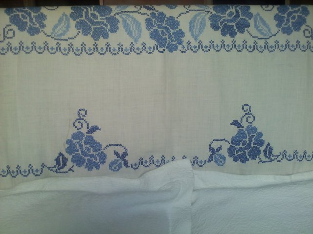 This hand-embroidered vintage linen tablecloth perfectly covers our headboard.